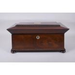 An antique rosewood sarcophagus shaped tea caddy with mother of pearl inlay, two handles and bun