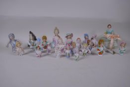 A collection of antique and vintage Continental porcelain pin cushion dolls, largest 12cm high