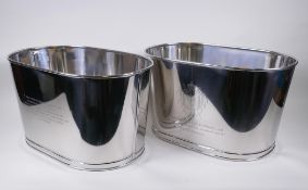 A pair of plated metal Champagne coolers, engraved with quotes from Lily Bollinger and Napoleon