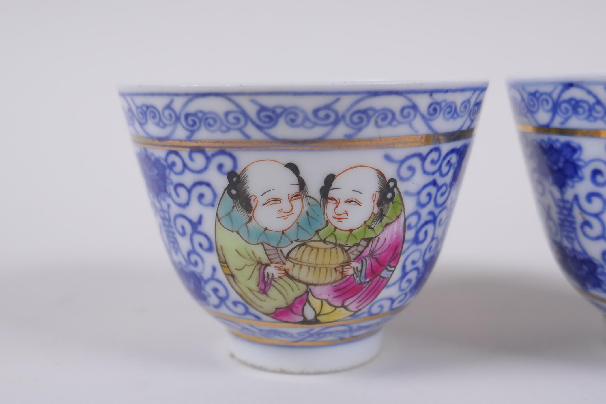 A pair of Chinese blue and white porcelain tea bowls with polychrome enamels panels depicting two - Image 2 of 5