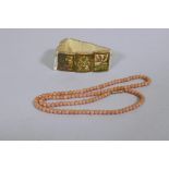 An antique coral necklace with 9ct gold clasp, 44cm long, and an Indian bone bracelet comprising