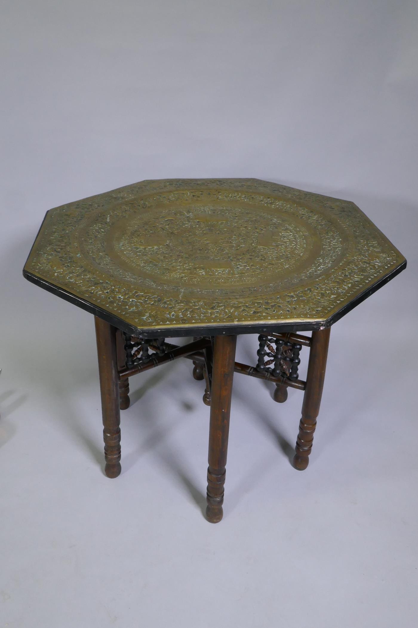 An antique Indo Persian octagonal brass tray table with repousse elephant and bird decoration, - Image 2 of 6