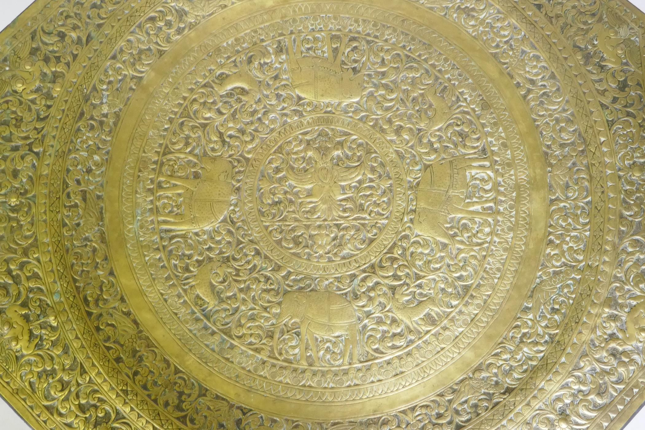 An antique Indo Persian octagonal brass tray table with repousse elephant and bird decoration, - Image 5 of 6