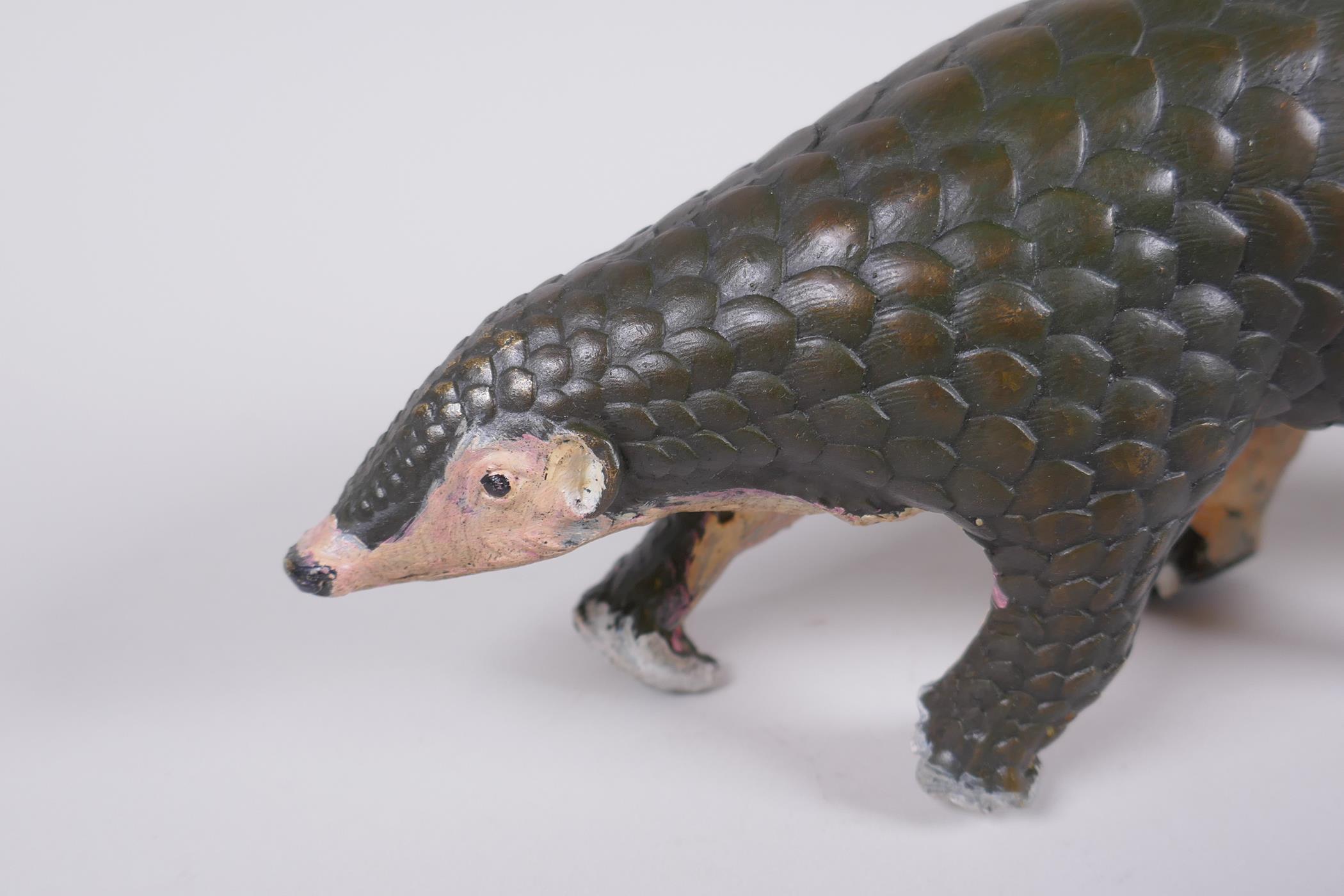 A cold painted filled bronze figure of a pangolin with a pup riding on its back, 32cm long - Image 2 of 5