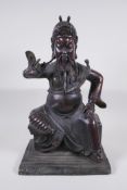 A large Chinese bronze figure of an immortal warrior seated on a throne, 45cm high