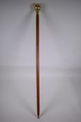 A brass handled walking stick with terrestrial globe handle, 94cm long