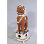 An Oriental painted and glazed terracotta figure of a temple lion, 78cm high
