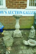 A reconstituted stone birdbath, 82cm high, a pair of planters and two garden figures