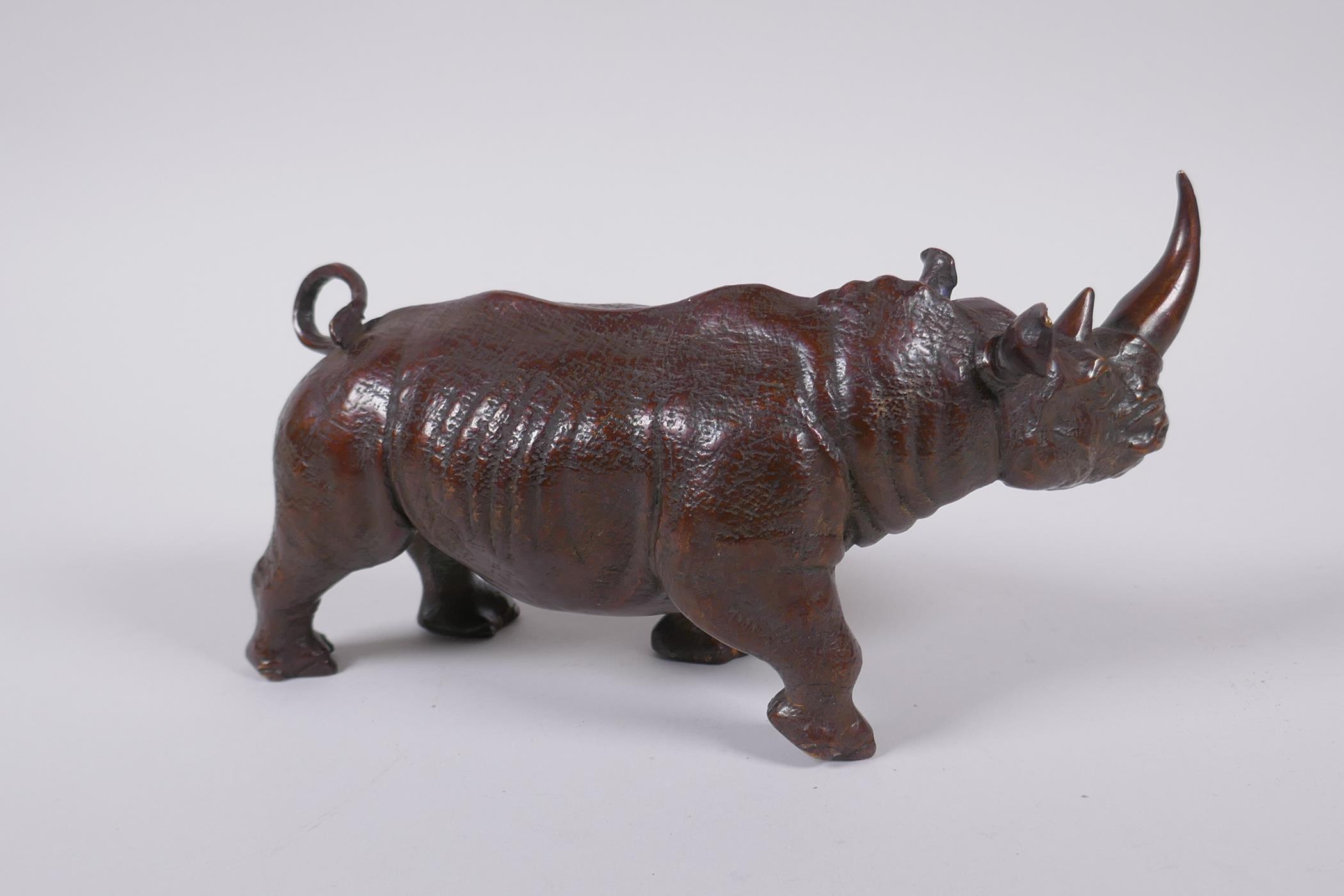 A filled bronze figure of a rhinoceros, 22cm long - Image 3 of 3