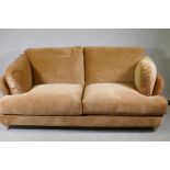 A Loaf Smithy sofa covered in Treacle Sponge Clever Velvet, raised on bleached oak