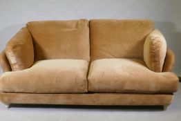 A Loaf Smithy sofa covered in Treacle Sponge Clever Velvet, raised on bleached oak