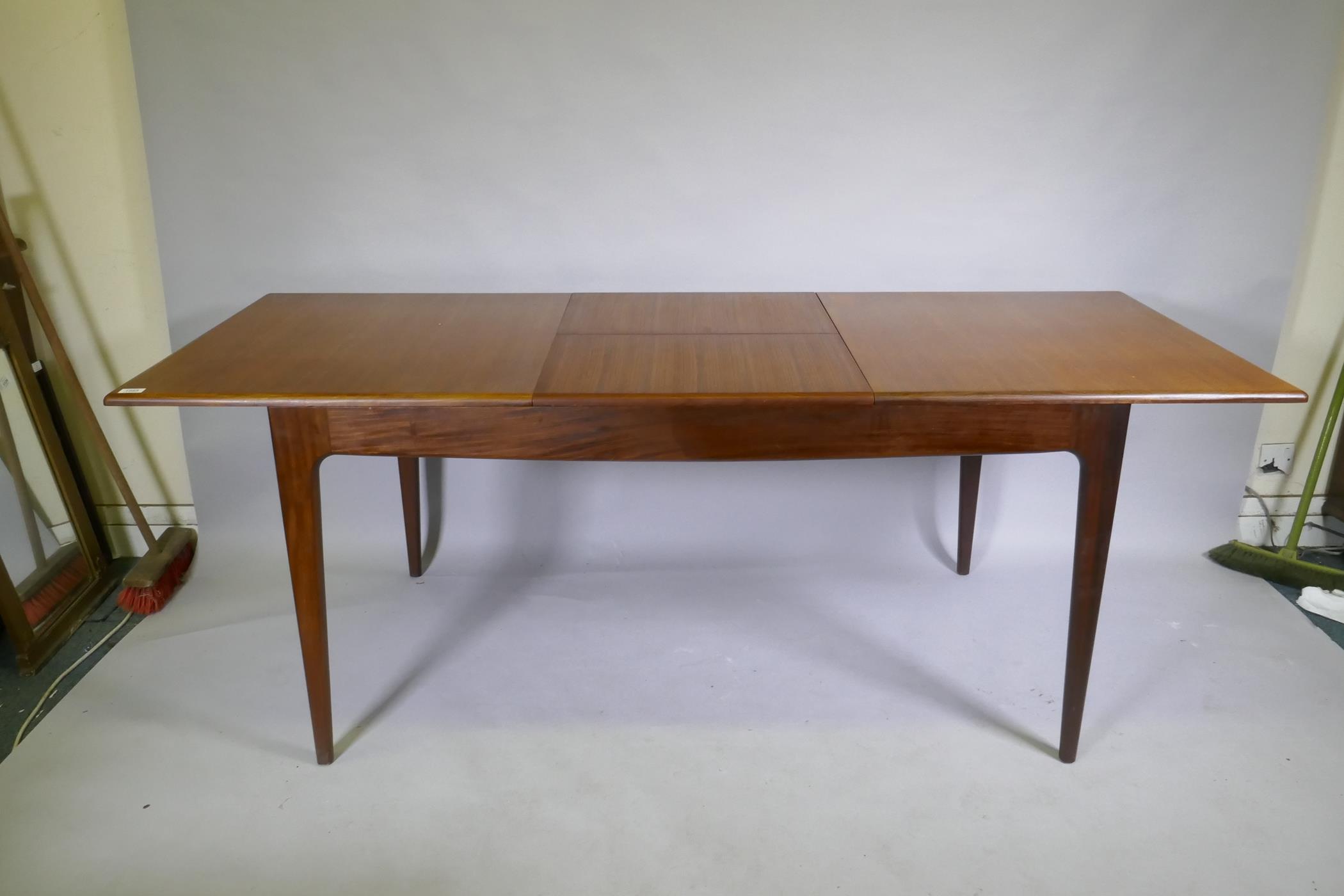 A mid century teak extending dining table, with folding leaf, designed by John Herbert for A. - Image 5 of 5