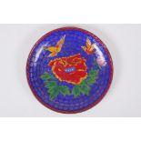 A Chinese blue ground cloisonne dish decorated with birds and flowers, 18cmn diameter