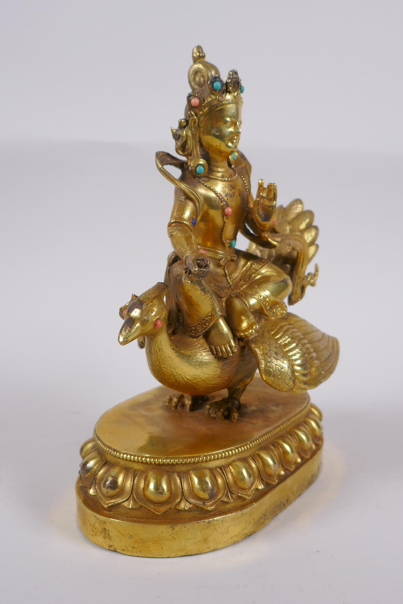 A Sino Tibetan gilt bronze figure of Buddha seated on the back of a phoenix, with inset coral, - Image 4 of 6