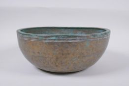 A C19th Tibetan hammered silvered bronze singing bowl, 27cm diameter