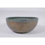 A C19th Tibetan hammered silvered bronze singing bowl, 27cm diameter