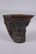 A Chinese faux horn libation cup with carved figural decoration, seal mark to base, 14cm high