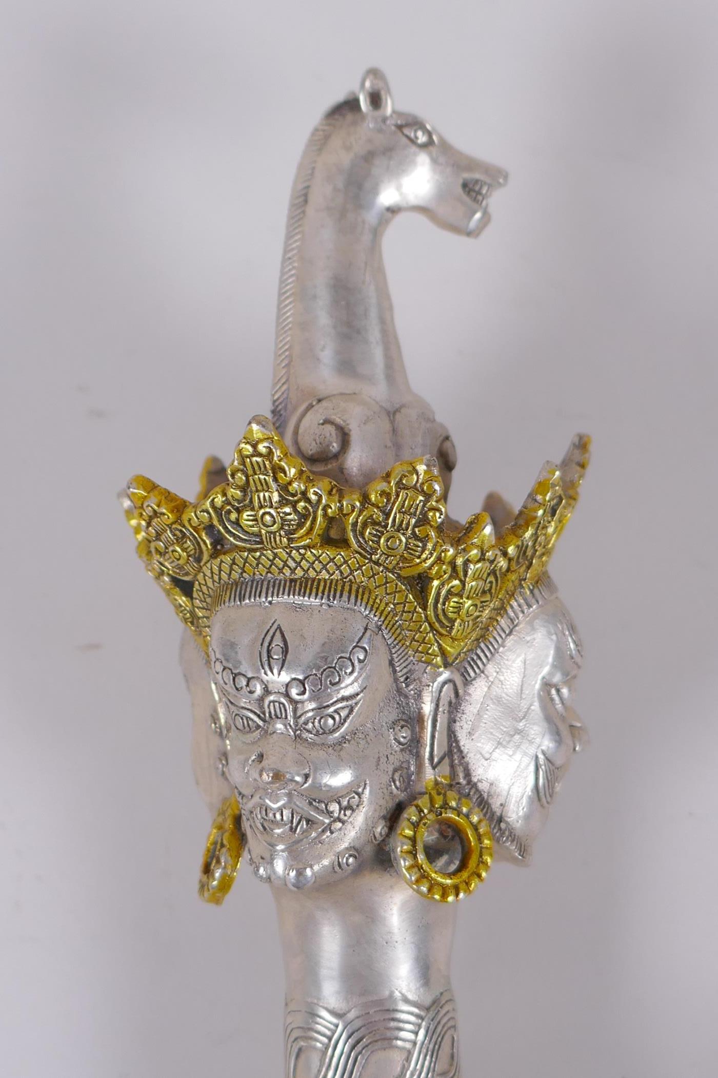 A Tibetan white metal kartika, the handle decorated with wrathful deity masks, 27cm - Image 2 of 5