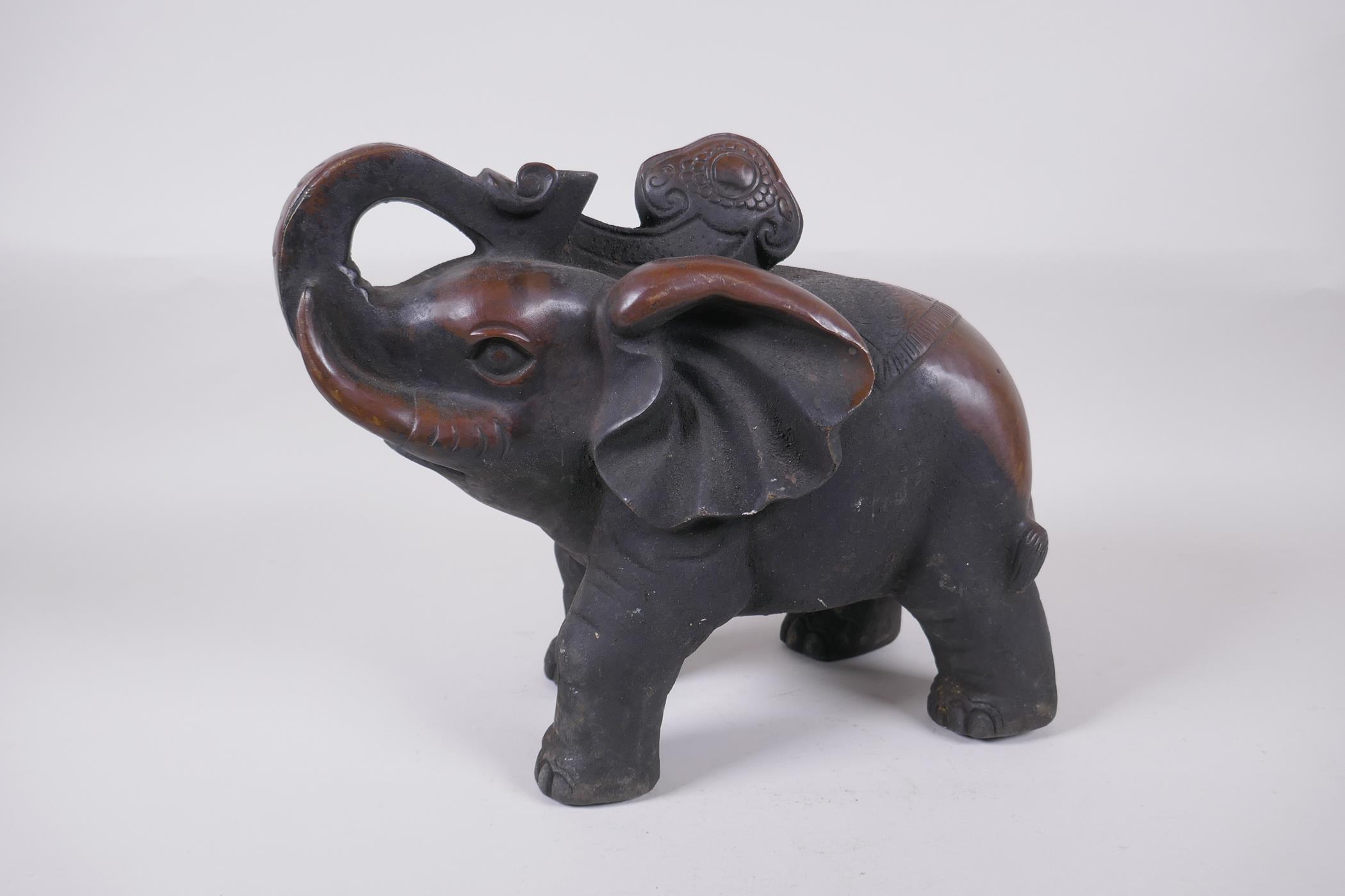 An oriental bronze figure of an elephant, 29cm long