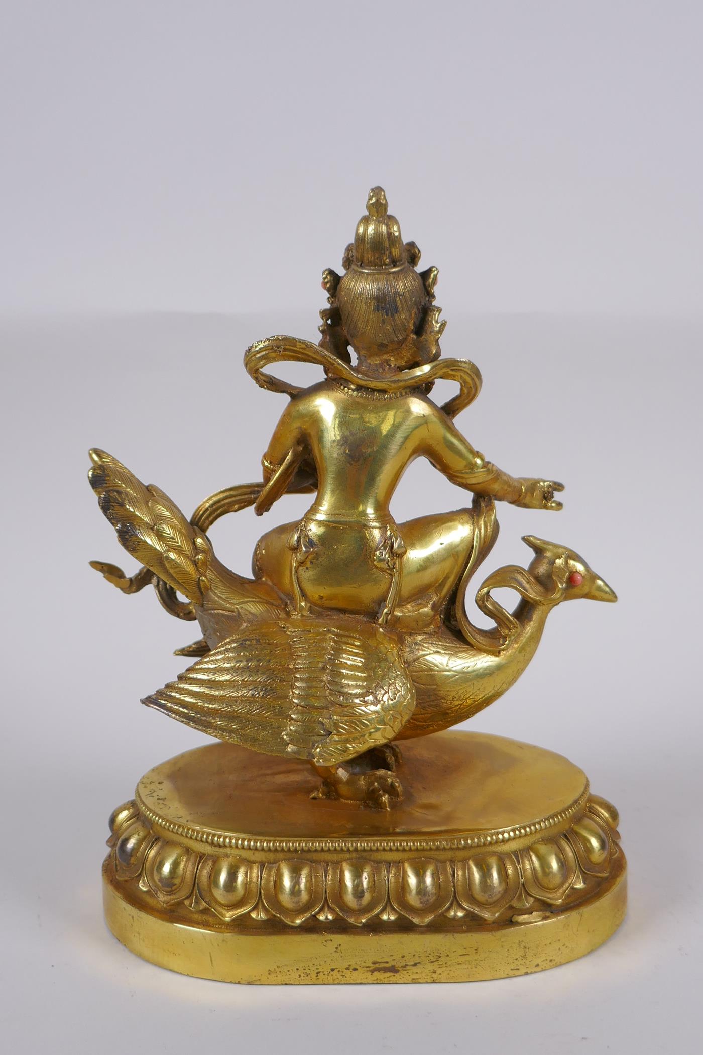 A Sino Tibetan gilt bronze figure of Buddha seated on the back of a phoenix, with inset coral, - Image 5 of 6