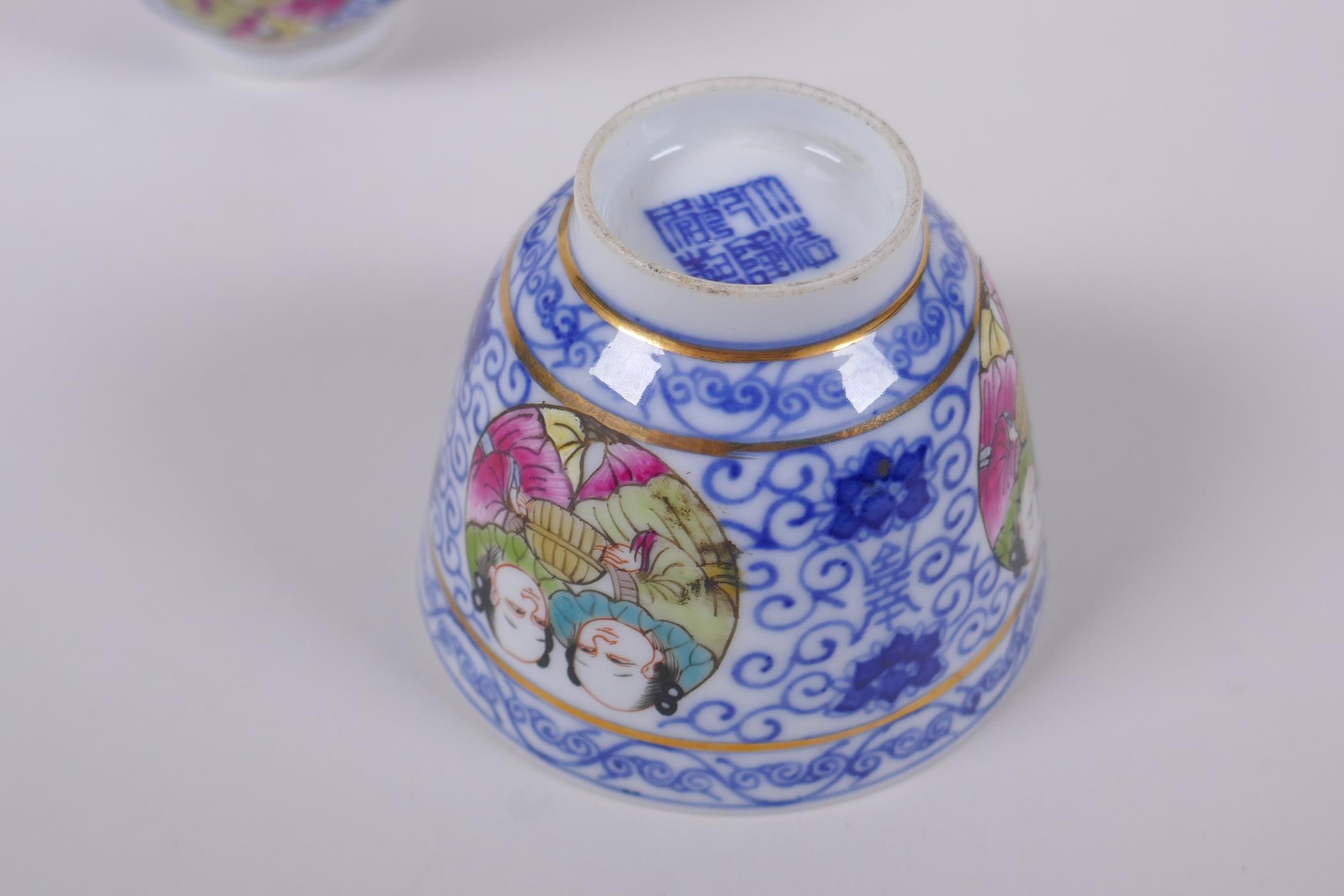 A pair of Chinese blue and white porcelain tea bowls with polychrome enamels panels depicting two - Image 4 of 5