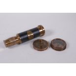 A reproduction brass sundial compass and a brass and leatherette miniature telescope, 13cm long