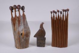 Two African carved hardwood female figure groups with traditional material headdresses, and an