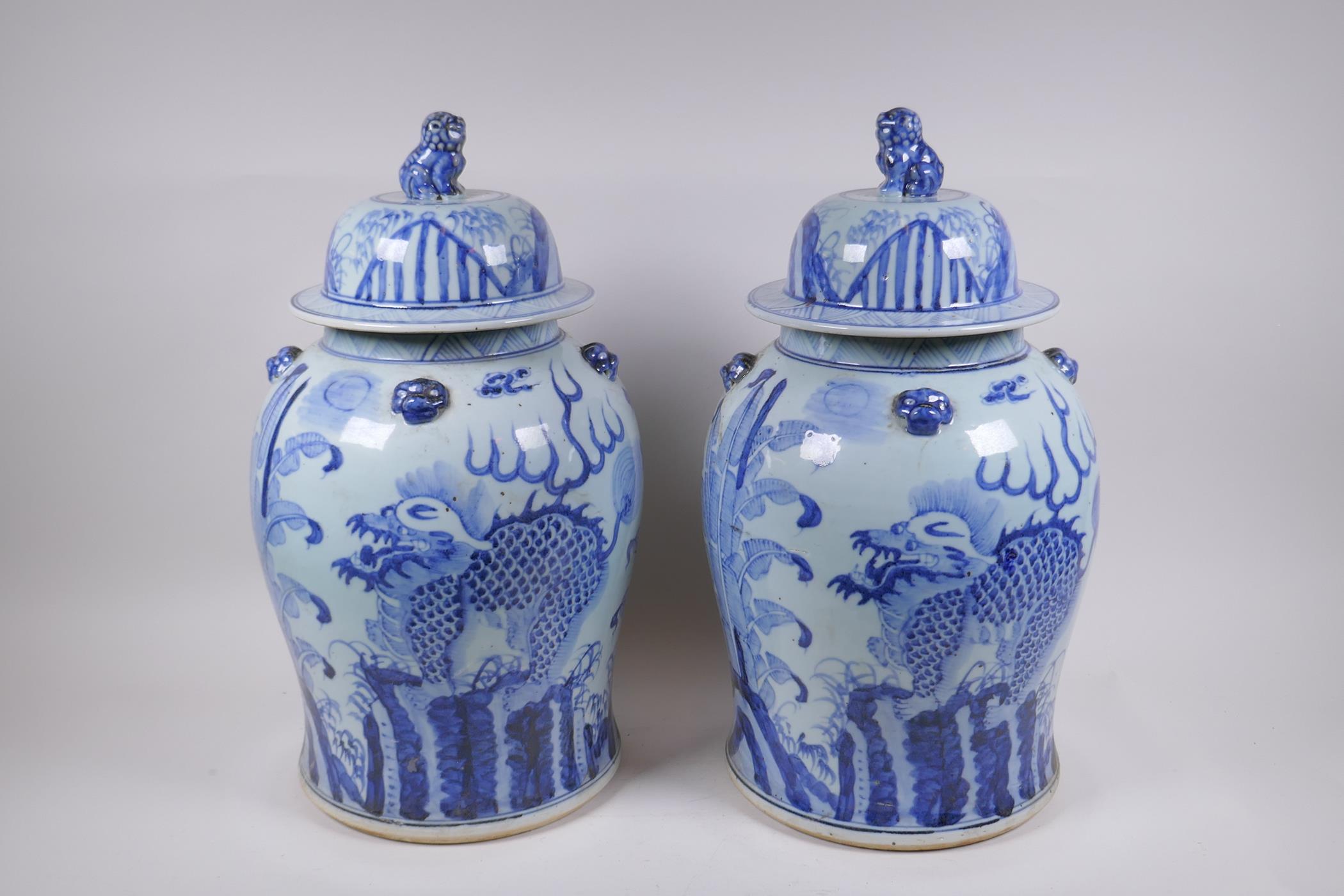 A pair of Chinese blue and white porcelain jars and covers with lion mask, kylin and Fo-dog