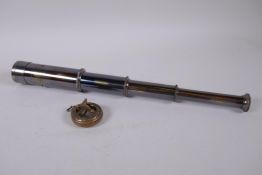 A reproduction brass fob watch sundial compass, and a four draw brass telescope, 39cm long extended