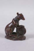 An oriental bronze figure of a rat with a Chinese coin, 3 character mark to base, 6cm high