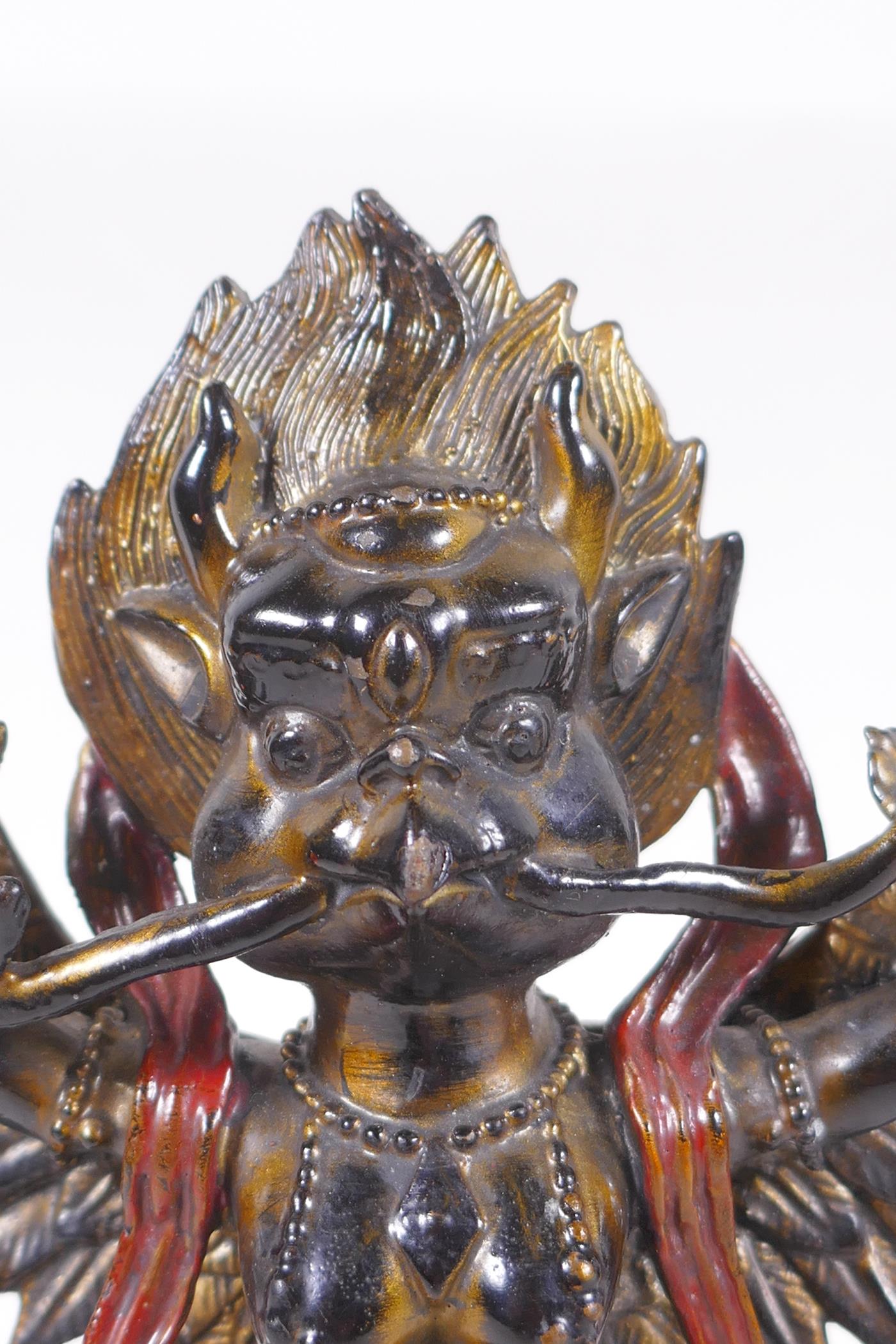 A Tibetan lacquered and gilt bronze of Garuda standing on the back of a figure, 17cm high - Image 3 of 6