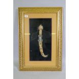 An Arab Jambiya dagger, mounted in a gilt frame, 55 x 80cm