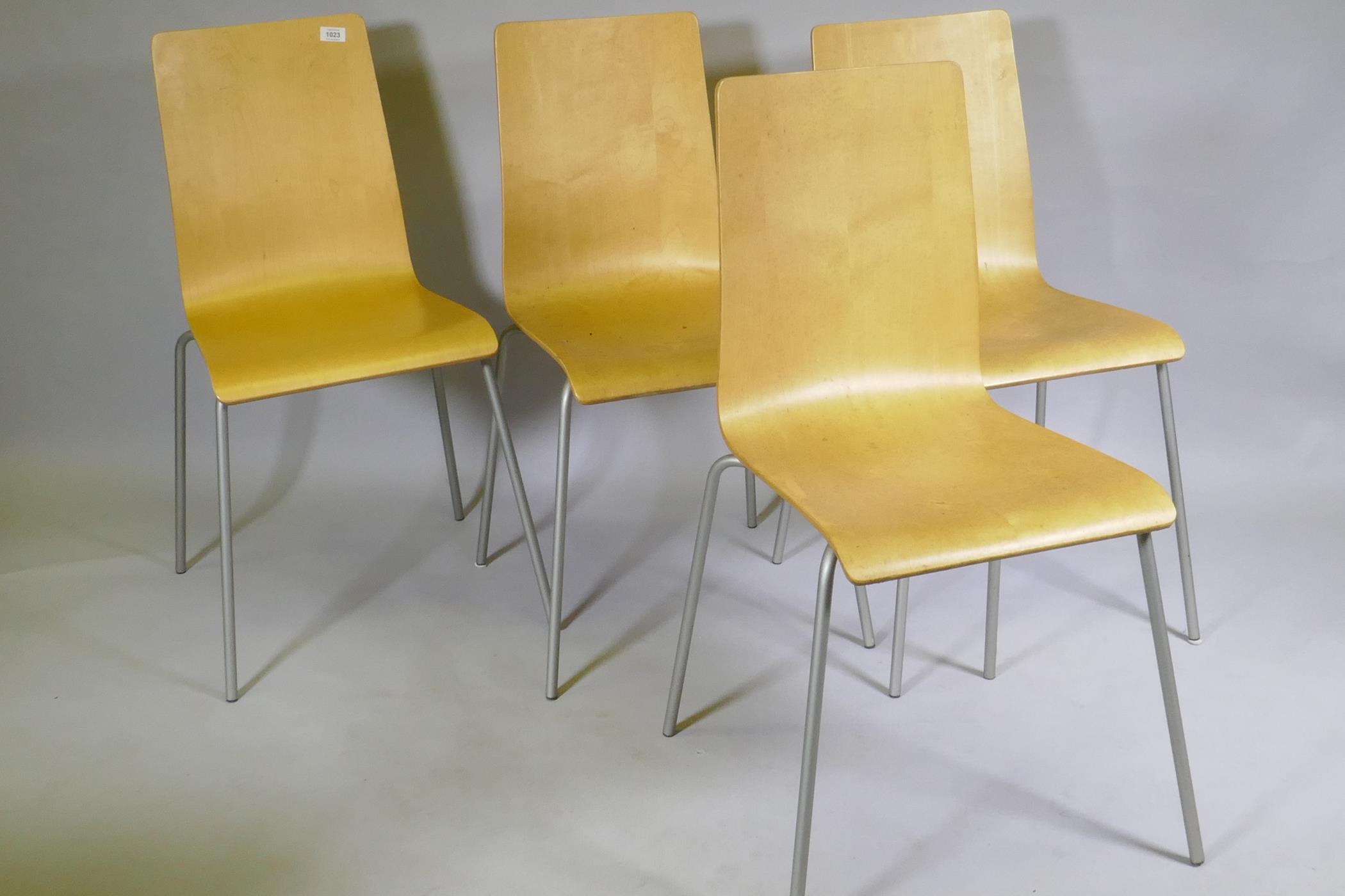 A set of four contemporary stacking bent plywood chairs in birchwood veneer