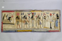 An early C20th Egyptian quilted cushion cover decorated with gods and pharaohs, 124 x 47cm