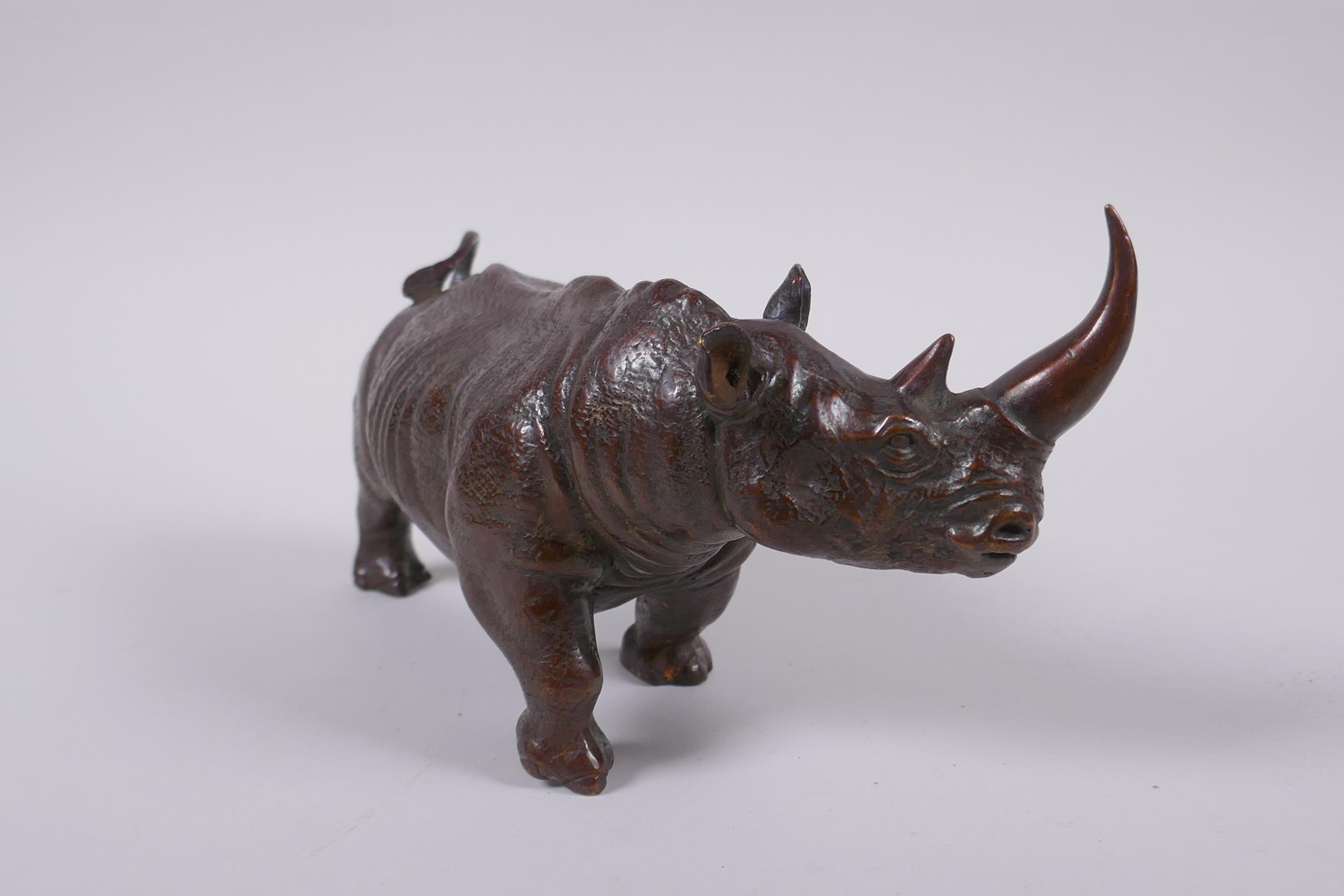 A filled bronze figure of a rhinoceros, 22cm long - Image 2 of 3