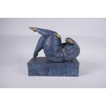 A contemporary patinated bronze sculpture of a stylised reclining female nude, 26cm long