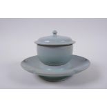 A Chinese Ru ware style tea set comprising a tea bowl, cover and petal shaped saucer, 18cm diameter