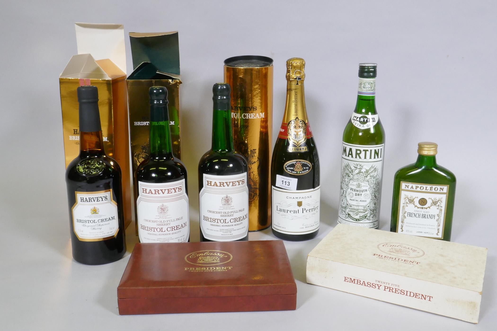 A box of 25 Embassy President Corona cigars, 3 bottles of Harveys Bristol Cream sherry, Vermouth,