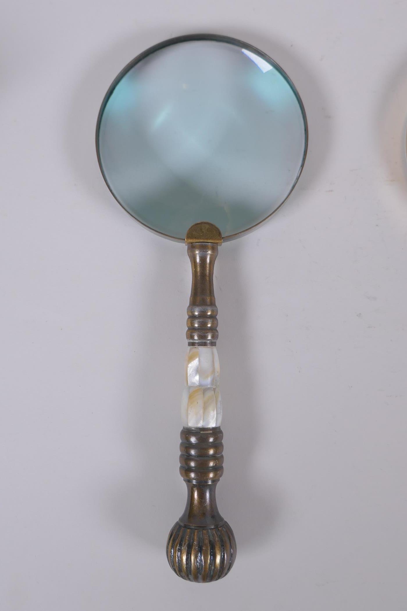 Two brass magnifying glasses with mother of pearl handles, and a similar chromed metal magnifying - Image 2 of 4
