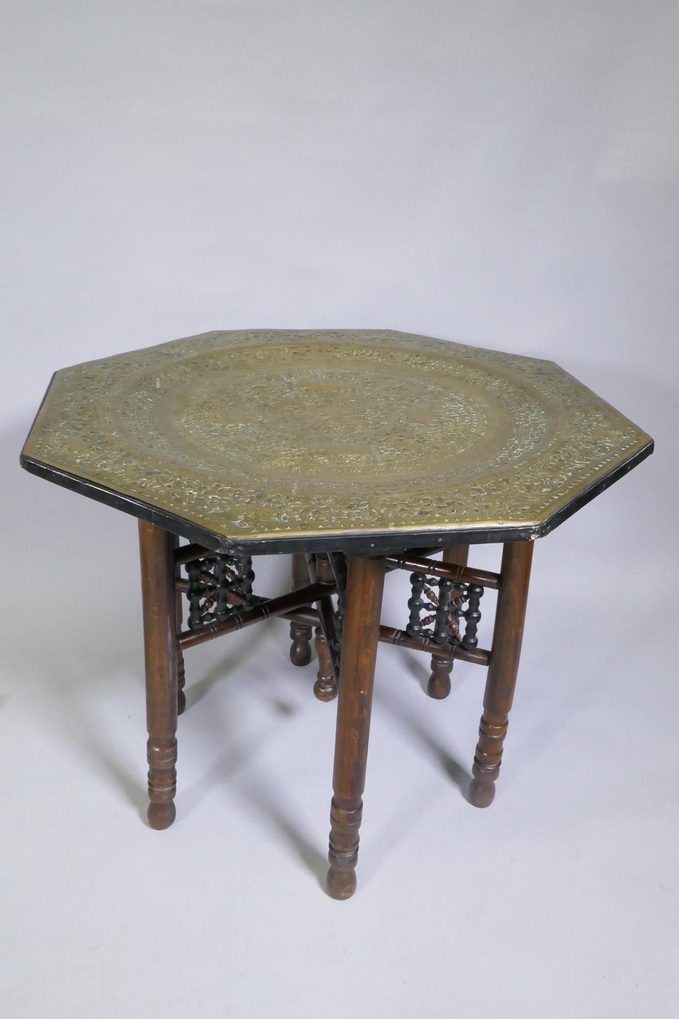 An antique Indo Persian octagonal brass tray table with repousse elephant and bird decoration, - Image 4 of 6