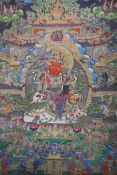 A Tibetan printed thangka depicting a wrathful deity, 66 x 89cm