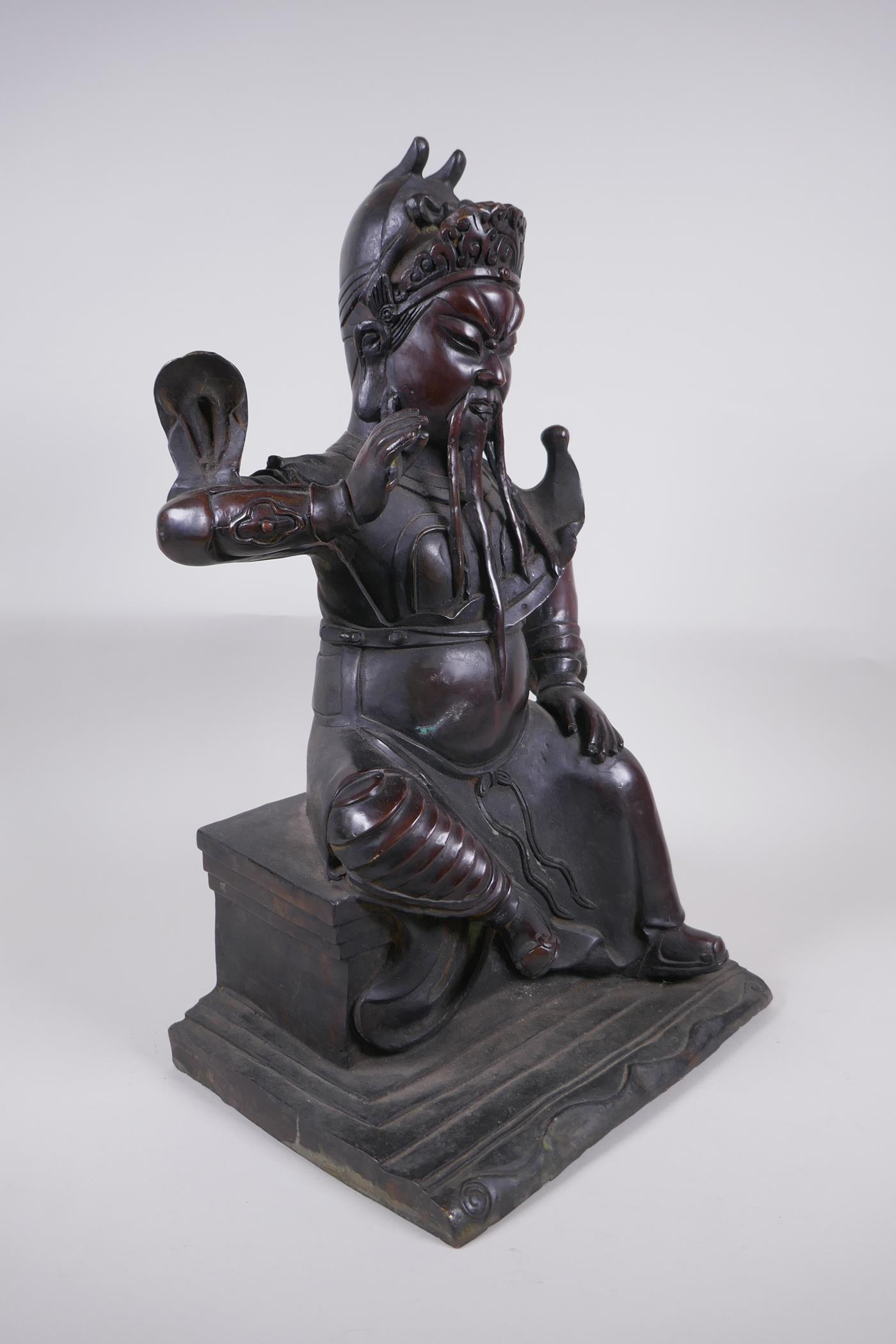 A large Chinese bronze figure of an immortal warrior seated on a throne, 45cm high - Image 3 of 5