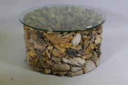 A driftwood glass topped coffee table, 74cm diameter, 40cm high