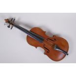 An antique half size violin with a two piece back and ebony finger board, 46cm long
