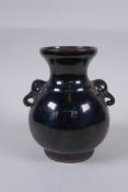 A Chinese treacle glazed crackle ware vase with two elephant mask handles, 15cm high