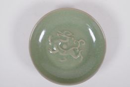 A Chinese celadon crackle glazed porcelain dish with underglaze dragon, 18cm diameter