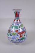 A Wucai porcelain pear shape vase decorated with carp in a lotus pond, Chinese Xuande 6 character