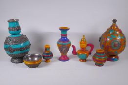 A collection of Sino Tibetan faux amber vases, jugs and bowls, with white metal mounts and set