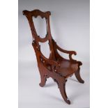 An antique elm child's high back arm chair, 72cm high