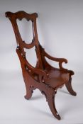 An antique elm child's high back arm chair, 72cm high